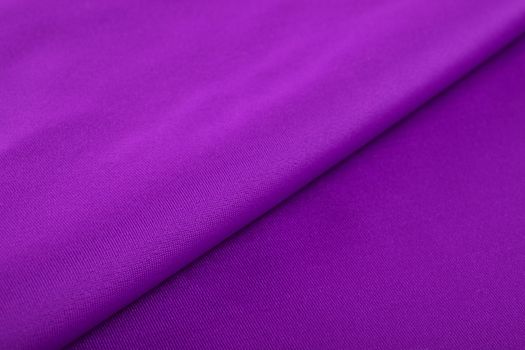 purple Knitted elastic fabric, weaving of threads texture, crumpled fold. For underwear, sports clothes and swimwear. Space for text.