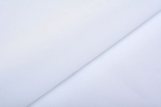 white Knitted elastic fabric, weaving of threads texture, crumpled fold. For underwear, sports clothes and swimwear. Space for text.