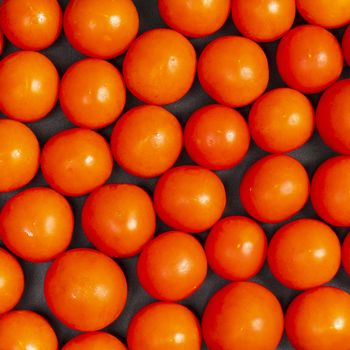 some small tomatoes on a black table