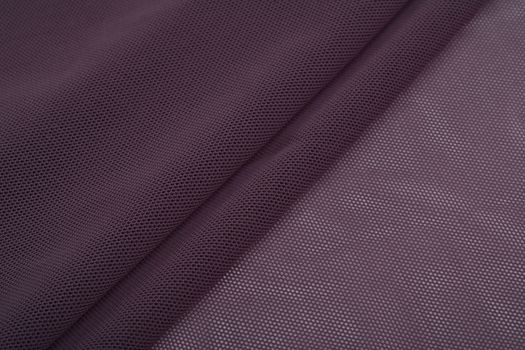 purple Knitted elastic fabric, weaving of threads texture, crumpled fold. For underwear, sports clothes and swimwear. Space for text.