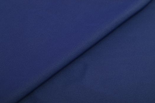 blue Knitted elastic fabric, weaving of threads texture, crumpled fold. For underwear, sports clothes and swimwear. Space for text.