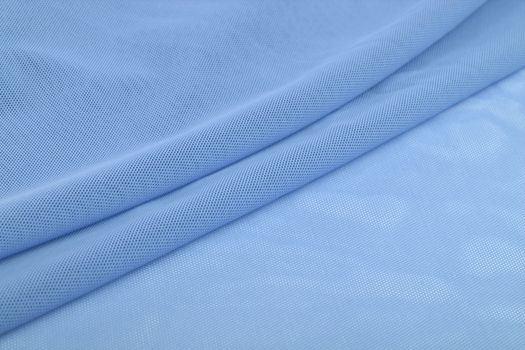 blue Knitted elastic fabric, weaving of threads texture, crumpled fold. For underwear, sports clothes and swimwear. Space for text.