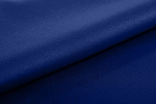 blue Knitted elastic fabric, weaving of threads texture, crumpled fold. For underwear, sports clothes and swimwear. Space for text.