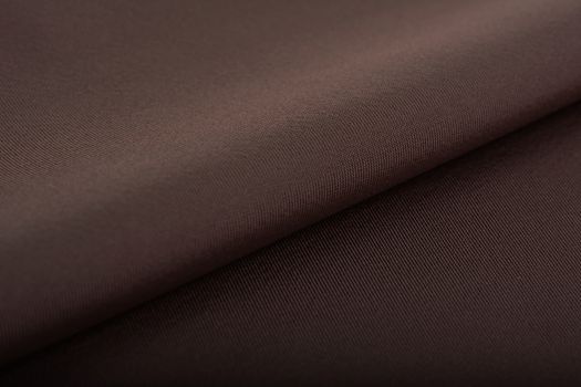 brown Knitted elastic fabric, weaving of threads texture, crumpled fold. For underwear, sports clothes and swimwear. Space for text.