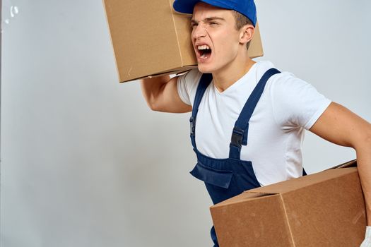 Man worker with box in hands delivery loading service packing service. High quality photo