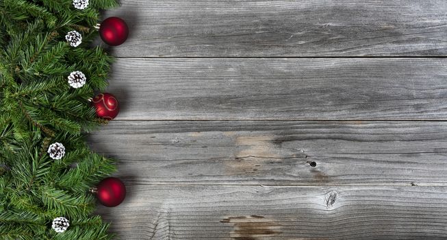 Merry Christmas and Happy New Year holiday concept with decorations on left side of rustic wooden boards