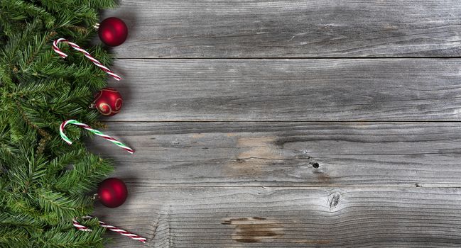 Merry Christmas and Happy New Year holiday concept with decorations on left side of weathered wooden boards