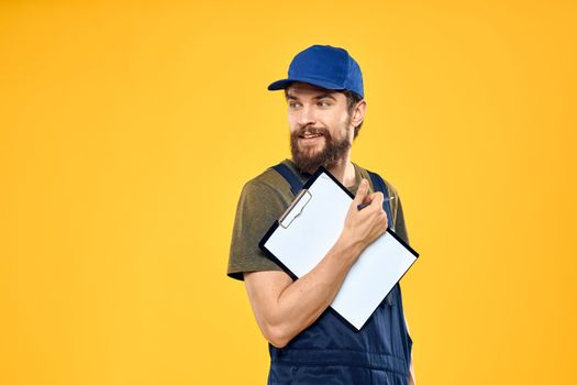 Man in working form documents transportation delivery service yellow background. High quality photo