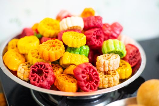 shot of colorful Fryums being deep fried in hot oil bubbling and sizzling with bubbles forming and size increasing of this popular north indian snack and street food. This sago and potato starch delicacy is a popular snack that is unhealthy but very tasty