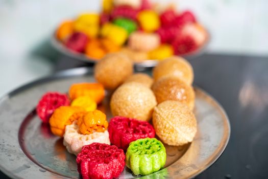 shot of colorful Fryums being deep fried in hot oil bubbling and sizzling with bubbles forming and size increasing of this popular north indian snack and street food. This sago and potato starch delicacy is a popular snack that is unhealthy but very tasty