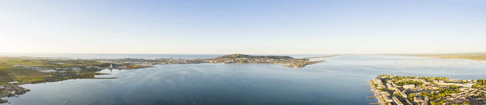 The Etang de Thau is a lagoon separated from the Gulf of Lion by a cord of coastal sand connecting the Agde volcano and the hill of Sète Mont Saint-Clair.