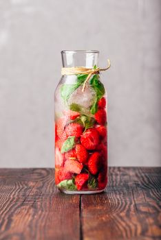 Bottle of Water Flavored with Fresh Strawberry and Basil Leaves. Vertical Orientation and Copy Space.