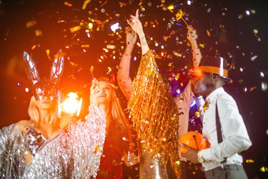 Happy people men and women mixed race dancing together on Halloween party