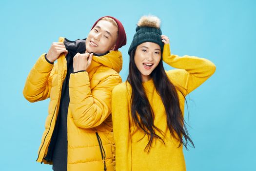 happy guy and a young woman in a yellow sweater laughing at the camera, winter fashion