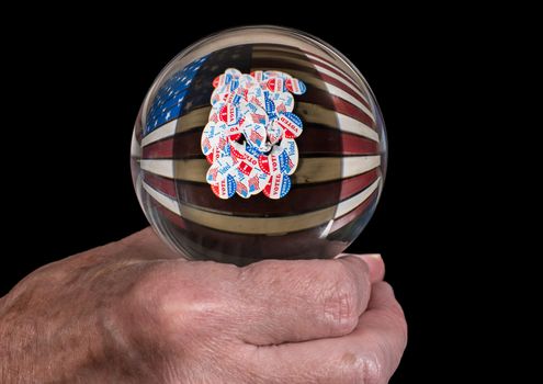Senior caucasian man's hand holding glass fortune tellers globe or ball to predict the result of the USA presidential election