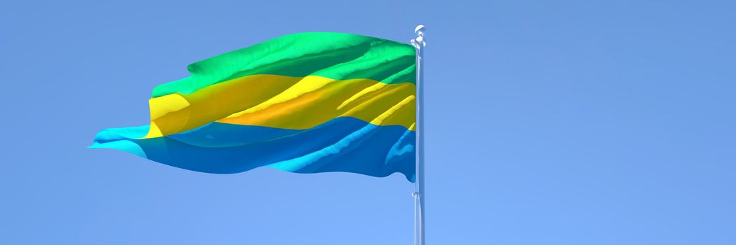 3D rendering of the national flag of Gabon waving in the wind against a blue sky.