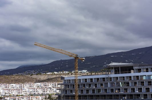 Tower crane with a long boom in the construction of buildings