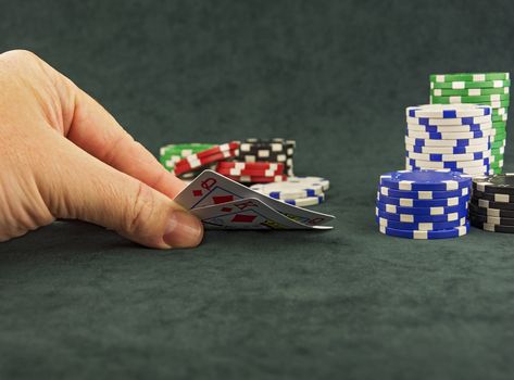 Cubes for poker and casino chips lying on the green cloth