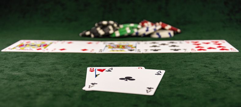 Poker distribution of cards lying on the green cloth