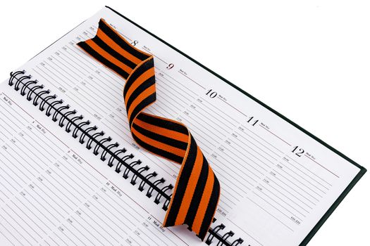 In an open diary sheet is St. George's ribbon twisted spiral