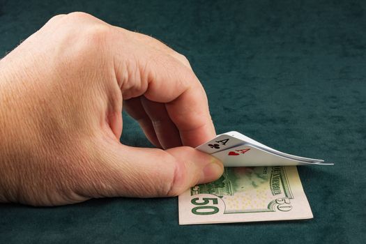 On the table lies banknotes and male hand picks up on her two cards