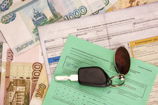 Documents of international car insurance, the ignition key and banknotes