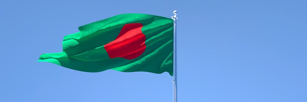 3D rendering of the national flag of Bangladesh waving in the wind against a blue sky