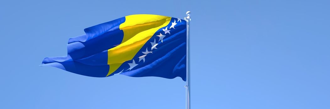 3D rendering of the national flag of Bosnia and Herzegovina waving in the wind against a blue sky