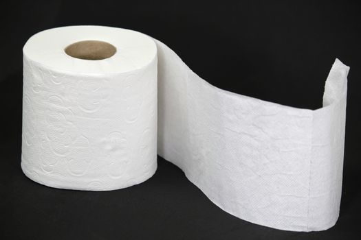 White toilet paper roll on black background