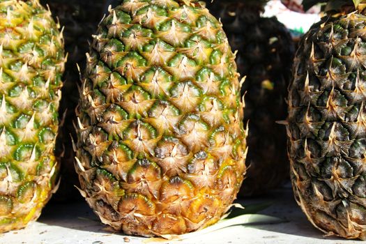 Colorful pineapples at a market stall in Santa Pola, Alicante, Spain