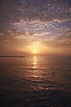 Rocky beach at sunrise, long exposure, foggy clouds