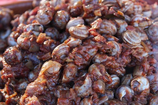 Snails with spicy tomato sauce for sale at a market stall in Spain