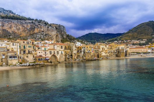 Panoramic view of the Sicilian coast in the city of Cefalu its traditional houses and the mountains that surround it a few kilometers from the city of Palermo