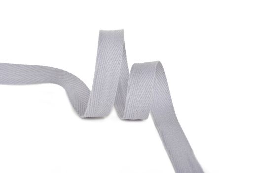 gray Twisted ribbon of cotton Keeper braid on white background. Tape For sewing clothes.