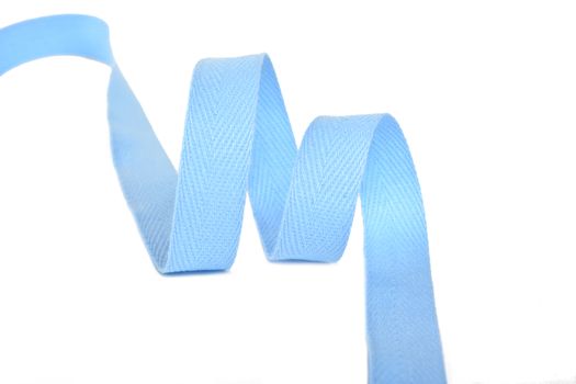 blue Twisted ribbon of cotton Keeper braid on white background. Tape For sewing clothes.