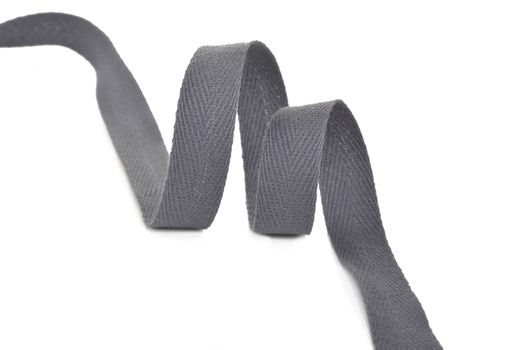 gray Twisted ribbon of cotton Keeper braid on white background. Tape For sewing clothes.