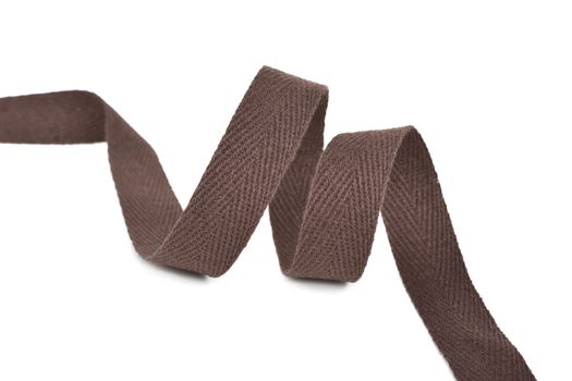 brown Twisted ribbon of cotton Keeper braid on white background. Tape For sewing clothes.