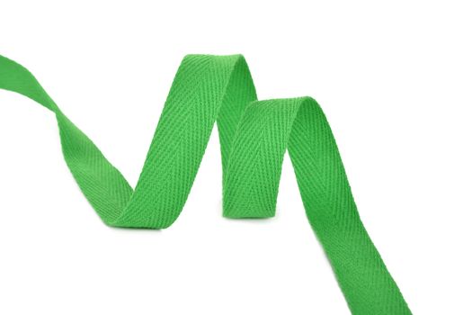 green Twisted ribbon of cotton Keeper braid on white background. Tape For sewing clothes.