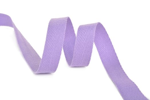 purple Twisted ribbon of cotton Keeper braid on white background. Tape For sewing clothes.