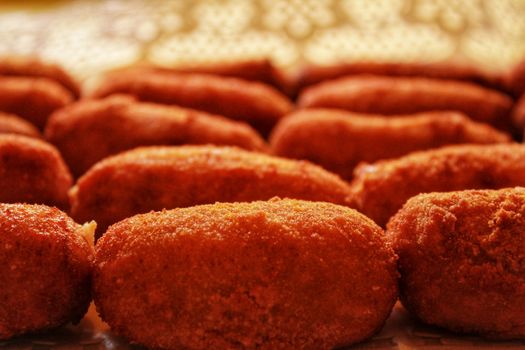 Typical spanish Croquettes put in a tray in a restaurant ready to eat