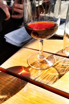 Glass of tasty port wine tawny porto on a table in a cafe in Lisbon