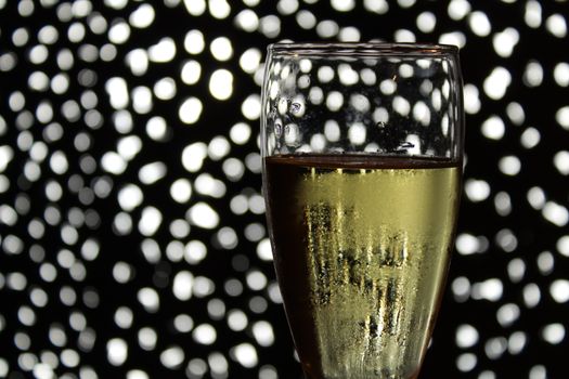 Champagne glass over Christmas light fantasy bokeh