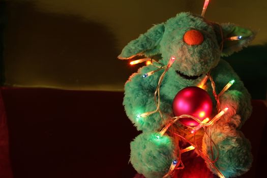 Teddy bear with Christmas tree balls, garlands and other colorful decorative elements