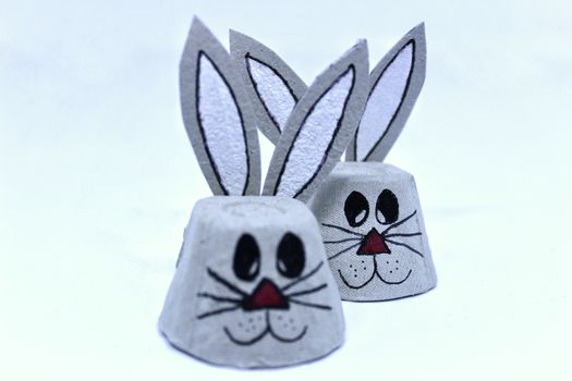 Easter bunnies made of cardboard egg cups. White background
