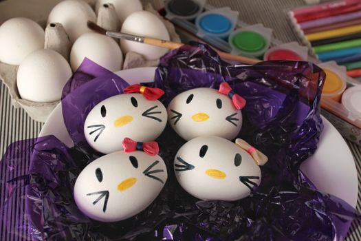 Kitty easter eggs, paint and brush on purple cellophane paper