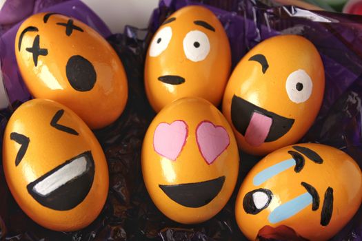Emoticons Easter Eggs on purple cellophane paper