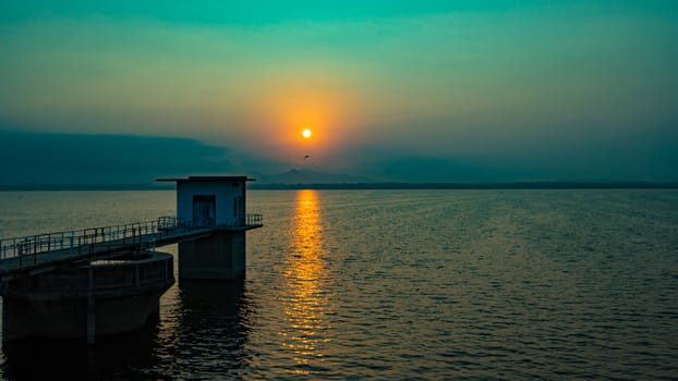 lighthouse on the dam with sunrise