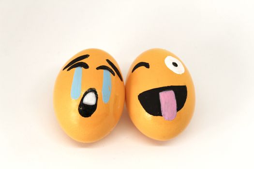 Smiling and crying Emoticons Easter Eggs and white background.