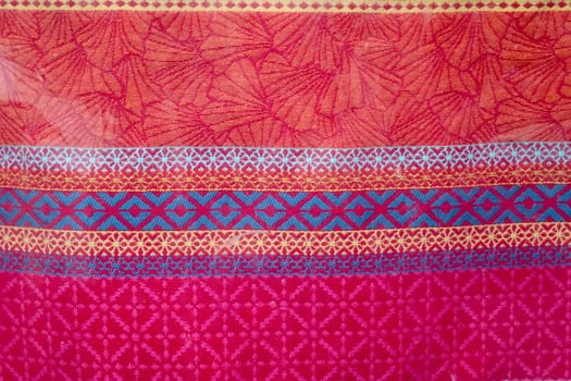 Detailed close up view on samples of cloth and fabrics in different colors found at a fabrics market.