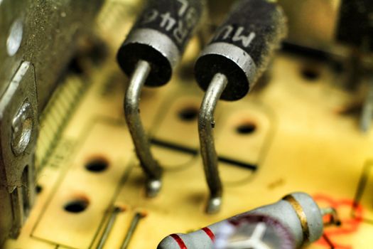 Macro photography of capacitors and other electronic components in an electronic board
